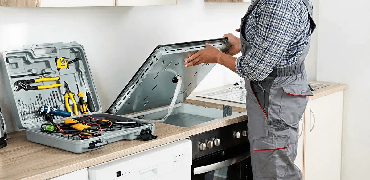 Handyman repairing a cooktop and checking wiring connections in Myrtle Beach, SC