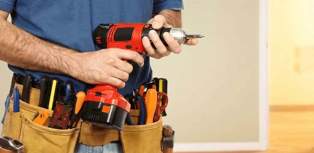 Handyman holding a power drill for home repairs and installations in Myrtle Beach, SC