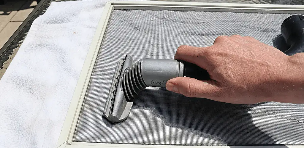 Window screen repair cleaning and fixing a damaged screen mesh in Myrtle Beach, SC